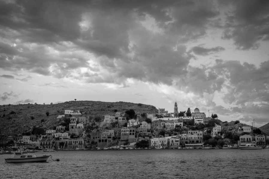 Church tower and clouds above Symi, Greece.