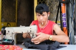 Young guy sewing in Saigon